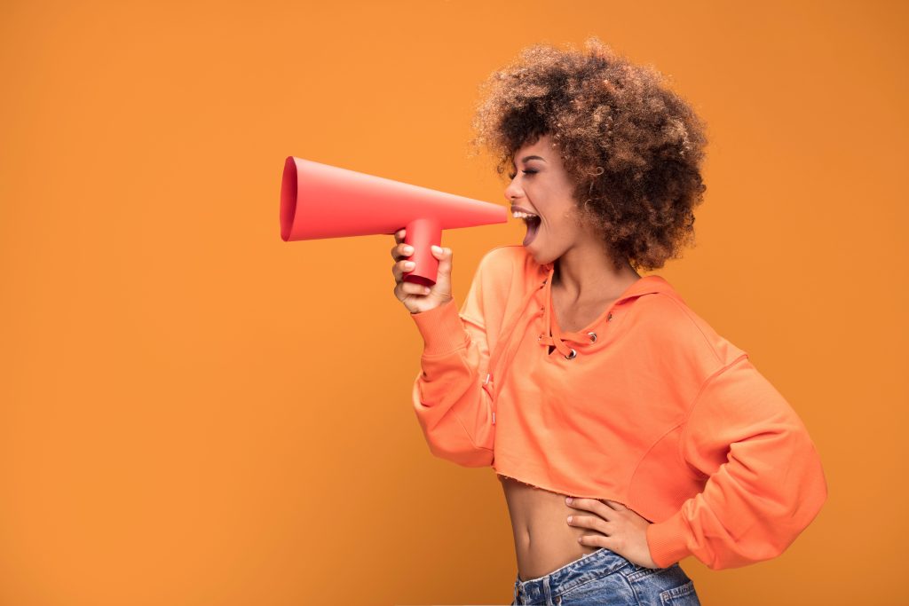 Orange woman megaphone resized | Vox | Affordable High-Speed Broadband, Plus Value-Adds, for Every South African